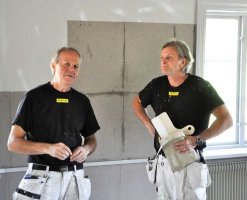 Anders Tynell och Stefan Nilsson sätter lumppapp på väggarna.
